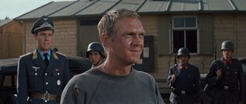 Movie still from “The Great Escape” (1963), directed by John Sturges – A person wearing a helmet; Close Up shot, Over the shoulder angle