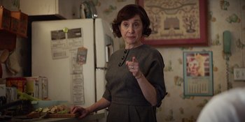 Movie still from “The Greatest Beer Run Ever” (2022), directed by Peter Farrelly – An older woman standing in front of a refrigerator in a kitchen; Medium shot, Over the shoulder angle
