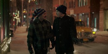 Movie still from “The Greatest Beer Run Ever” (2022), directed by Peter Farrelly – Two men holding hands while standing in the snow; Medium shot, Over the shoulder angle
