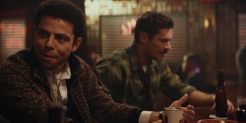 Movie still from “The Greatest Beer Run Ever” (2022), directed by Peter Farrelly – Two men sitting at a table with a cup of coffee; Close Up shot, Over the shoulder angle