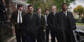 Movie still from “The Greatest Beer Run Ever” (2022), directed by Peter Farrelly – A group of men standing next to each other on a sidewalk; Medium shot, Low angle