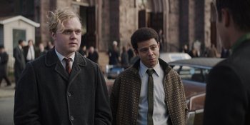 Movie still from “The Greatest Beer Run Ever” (2022), directed by Peter Farrelly – Two men are walking down the street together; Medium shot, Over the shoulder angle