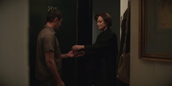 Movie still from “The Greatest Beer Run Ever” (2022), directed by Peter Farrelly – A woman and a man shaking hands in front of a door; Medium shot, Over the shoulder angle