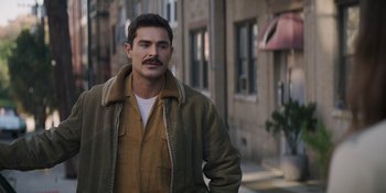Movie still from “The Greatest Beer Run Ever” (2022), directed by Peter Farrelly – A man with a mustache standing in front of a building; Close Up shot, Over the shoulder angle