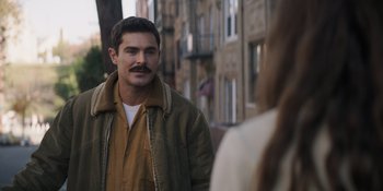 Movie still from “The Greatest Beer Run Ever” (2022), directed by Peter Farrelly – A man with a mustache standing next to a woman; Close Up shot, Over the shoulder angle