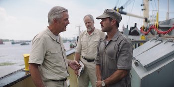 Movie still from “The Greatest Beer Run Ever” (2022), directed by Peter Farrelly – A group of men standing next to each other on top of a boat; Medium shot, Over the shoulder angle