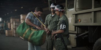 Movie still from “The Greatest Beer Run Ever” (2022), directed by Peter Farrelly – A group of men standing next to each other; Medium shot, Over the shoulder angle