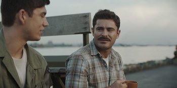 Movie still from “The Greatest Beer Run Ever” (2022), directed by Peter Farrelly – A man with a mustache sitting next to another man; Close Up shot, Over the shoulder angle