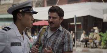 Movie still from “The Greatest Beer Run Ever” (2022), directed by Peter Farrelly – A man with a mustache talking to another man; Medium shot, Over the shoulder angle