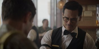 Movie still from “The Greatest Beer Run Ever” (2022), directed by Peter Farrelly – A man wearing a black bow tie and a white shirt; Close Up shot, Over the shoulder angle