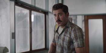 Movie still from “The Greatest Beer Run Ever” (2022), directed by Peter Farrelly – A man with a mustache standing next to a window; Close Up shot, Over the shoulder angle