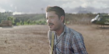 Movie still from “The Greatest Beer Run Ever” (2022), directed by Peter Farrelly – A person wearing a plaid shirt and holding a baseball bat; Close Up shot, Over the shoulder angle