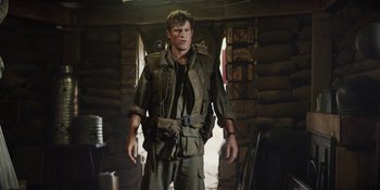 Movie still from “The Greatest Beer Run Ever” (2022), directed by Peter Farrelly – A man in a military uniform standing in a room; Medium shot, Over the shoulder angle