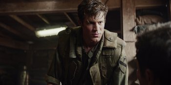 Movie still from “The Greatest Beer Run Ever” (2022), directed by Peter Farrelly – A man in a military uniform looking at the camera; Close Up shot, Over the shoulder angle