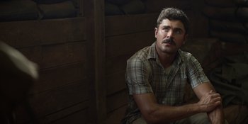 Movie still from “The Greatest Beer Run Ever” (2022), directed by Peter Farrelly – A man with a mustache sitting in a room; Close Up shot, Low angle