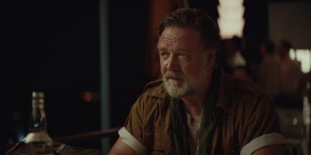 Movie still from “The Greatest Beer Run Ever” (2022), directed by Peter Farrelly – An older man with a beard is sitting in a chair; Close Up shot, Over the shoulder angle