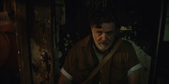 Movie still from “The Greatest Beer Run Ever” (2022), directed by Peter Farrelly – A man with a beard wearing a brown shirt; Close Up shot, Low angle