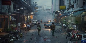 Movie still from “The Greatest Beer Run Ever” (2022), directed by Peter Farrelly – Two people walking down a street near a fire truck; Extreme Wide shot, High angle