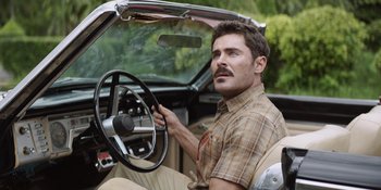 Movie still from “The Greatest Beer Run Ever” (2022), directed by Peter Farrelly – A man sitting in the driver's seat of a car; Medium shot, Over the shoulder angle