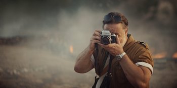 Movie still from “The Greatest Beer Run Ever” (2022), directed by Peter Farrelly – A man taking a picture with a camera; Close Up shot, Low angle