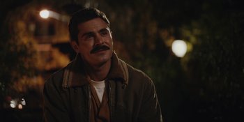 Movie still from “The Greatest Beer Run Ever” (2022), directed by Peter Farrelly – A man with a mustache is standing outside; Close Up shot, Over the shoulder angle