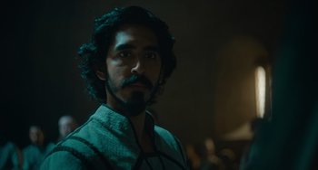 Movie still from “The Green Knight” (2021), directed by David Lowery – A person with a beard; Close Up shot, Over the shoulder angle