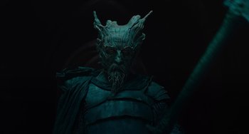 Movie still from “The Green Knight” (2021), directed by David Lowery – A person wearing a costume; Close Up shot, Low angle