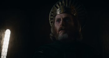 Movie still from “The Green Knight” (2021), directed by David Lowery – A person wearing a crown; Close Up shot, Low angle