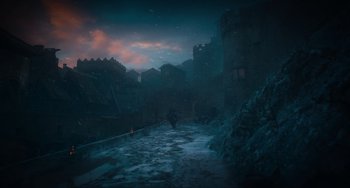 Movie still from “The Green Knight” (2021), directed by David Lowery – A snowy street with a castle in the background; Extreme Wide shot, Low angle