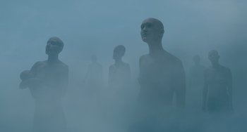 Movie still from “The Green Knight” (2021), directed by David Lowery – A group of people standing in the middle of a foggy area; Extreme Wide shot, Low angle