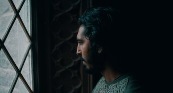 Movie still from “The Green Knight” (2021), directed by David Lowery – A person with a beard looking to the side; Close Up shot, Low angle