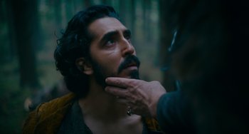 Movie still from “The Green Knight” (2021), directed by David Lowery – A person touching a man's face with his hand; Close Up shot, Over the shoulder angle