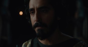 Movie still from “The Green Knight” (2021), directed by David Lowery – A person with a beard; Close Up shot, Over the shoulder angle