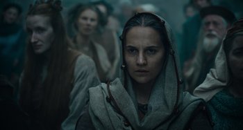 Movie still from “The Green Knight” (2021), directed by David Lowery – A woman with a hood over her head; Close Up shot, Low angle