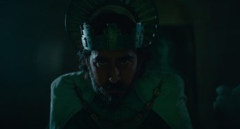 Movie still from “The Green Knight” (2021), directed by David Lowery – A man with a crown on his head and a beard; Medium shot, Low angle