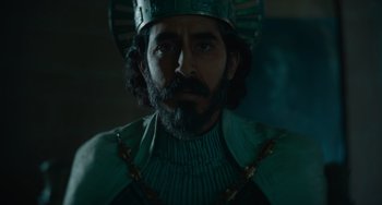 Movie still from “The Green Knight” (2021), directed by David Lowery – A person wearing a crown; Close Up shot, Low angle