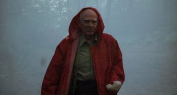 Movie still from “The Green Mile” (1999), directed by Frank Darabont – An old man wearing a red raincoat in the fog; Medium shot, Low angle