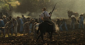Movie still from “The Green Mile” (1999), directed by Frank Darabont – A group of men on horses in a field; Wide shot, High angle