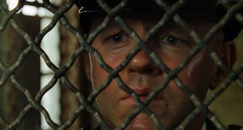 Movie still from “The Green Mile” (1999), directed by Frank Darabont – A person behind a chain link fence; Close Up shot, Overhead angle