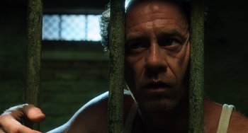 Movie still from “The Green Mile” (1999), directed by Frank Darabont – A man's face behind a tree; Close Up shot, Low angle