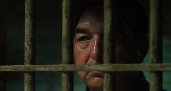 Movie still from “The Green Mile” (1999), directed by Frank Darabont – A man looking through the bars of a jail cell; Close Up shot, Low angle