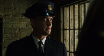 Movie still from “The Green Mile” (1999), directed by Frank Darabont – A man in a police uniform standing in front of a window; Close Up shot, Low angle