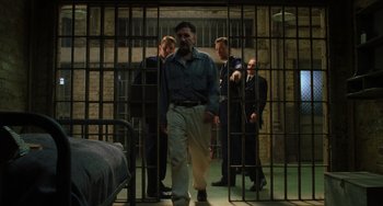 Movie still from “The Green Mile” (1999), directed by Frank Darabont – A group of men standing in a room behind bars; Wide shot, Low angle