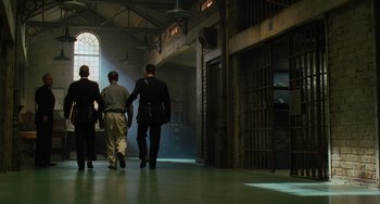 Movie still from “The Green Mile” (1999), directed by Frank Darabont – A group of people walking down a hall way; Wide shot, Low angle