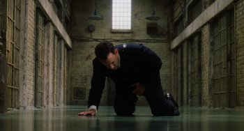 Movie still from “The Green Mile” (1999), directed by Frank Darabont – A man kneeling on the ground in a room; Wide shot, High angle