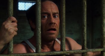 Movie still from “The Green Mile” (1999), directed by Frank Darabont – A person behind a fence; Close Up shot, High angle
