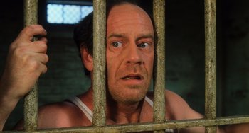 Movie still from “The Green Mile” (1999), directed by Frank Darabont – A person behind a fence; Close Up shot, High angle