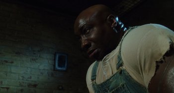 Movie still from “The Green Mile” (1999), directed by Frank Darabont – A man with a beard is standing in a room; Close Up shot, Low angle