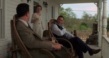 Movie still from “The Green Mile” (1999), directed by Frank Darabont – Two men and a woman sitting on a rocking chair; Medium shot, Over the shoulder angle