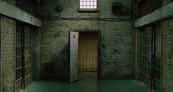 Movie still from “The Green Mile” (1999), directed by Frank Darabont – An open door in a room with a brick wall; Extreme Wide shot, High angle
